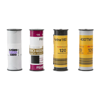 Four rolls of medium format film in various packaging designs.